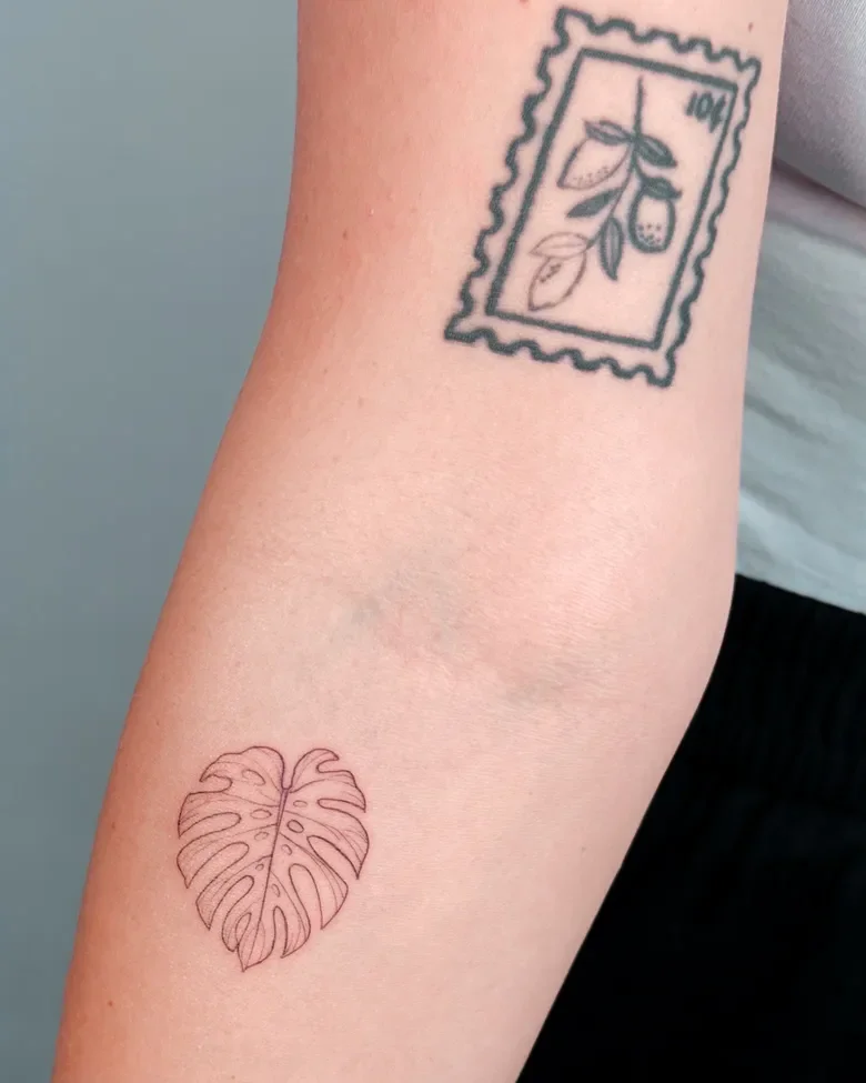Fine line postage stamp and monstera tattoo on the arm