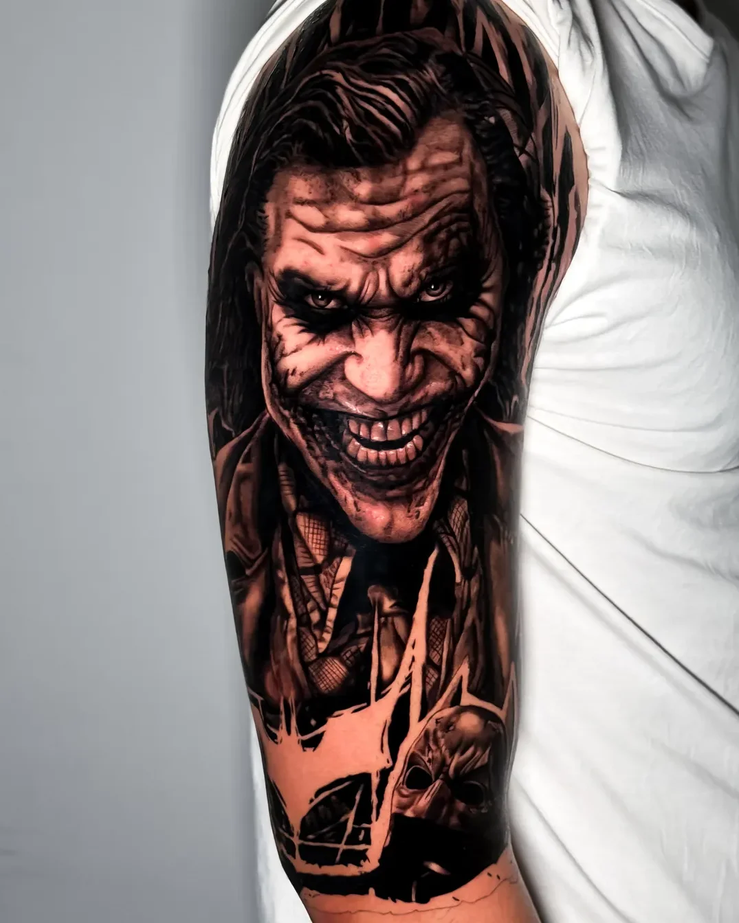 Realism Joker portrait tattoo on the arm