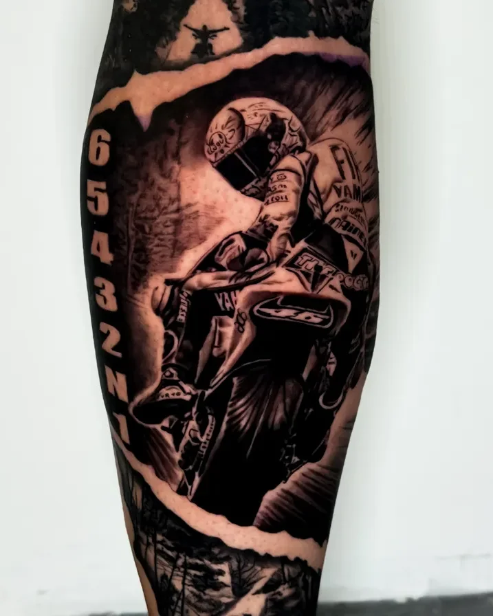 Realism motocross rider and mountain scene tattoo on the calf