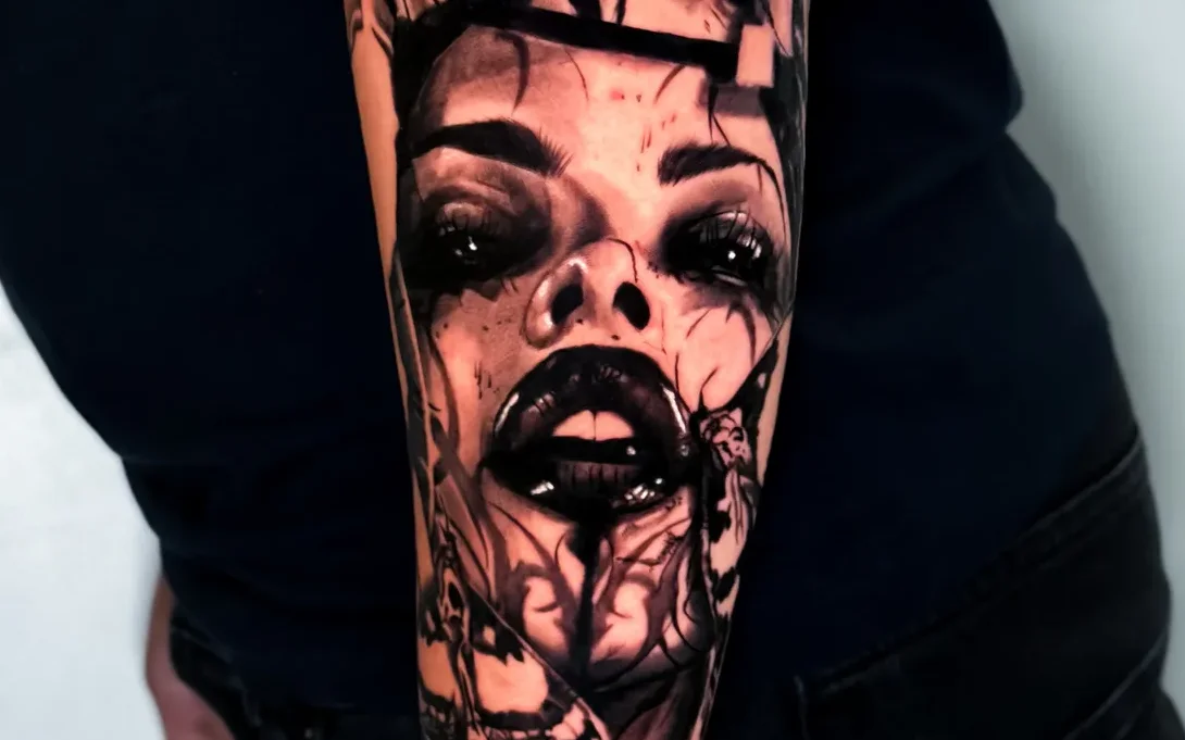 Surreal black and grey portrait tattoo on the arm