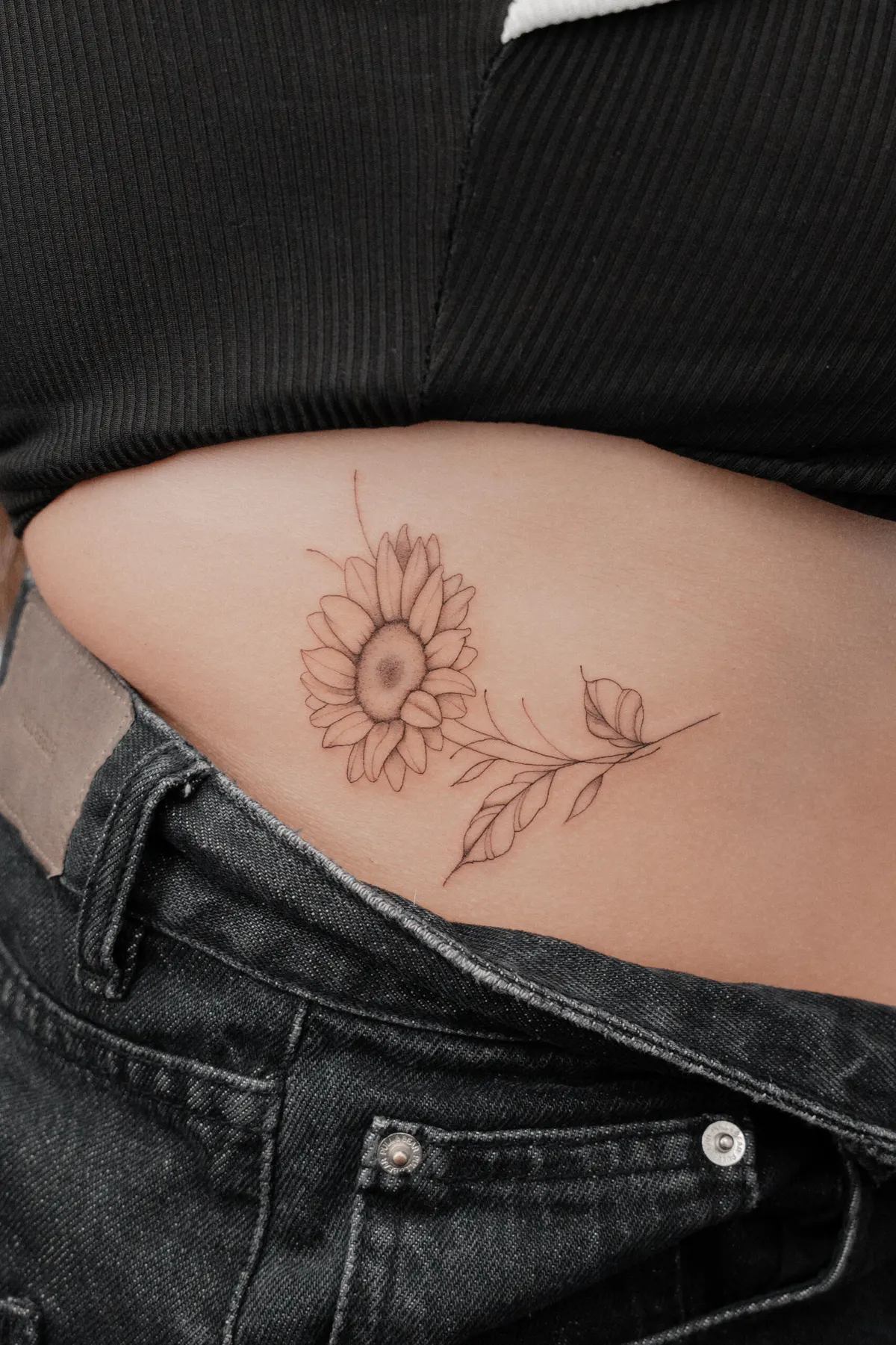 Fine line sunflower tattoo by Hugo Gonzalez