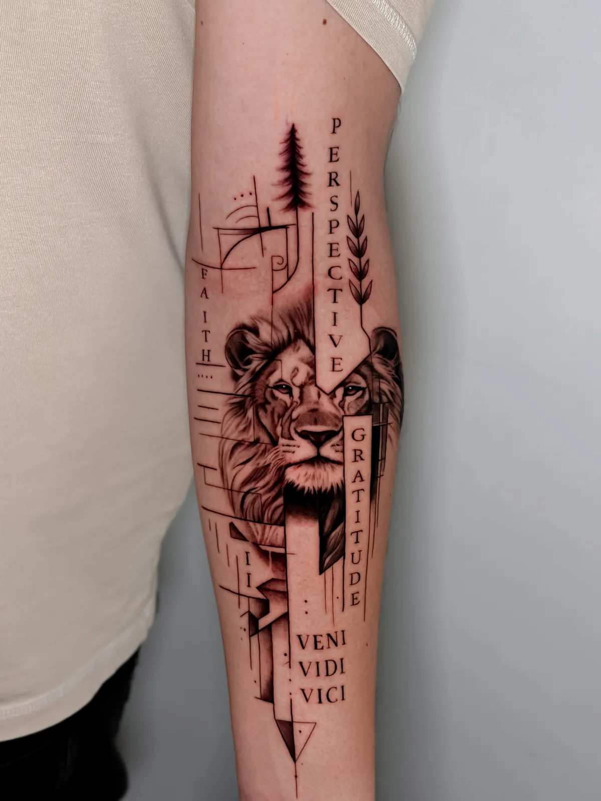 Graphic lion on the forearm with geometric lines and lettering by Hugo Gonzalez