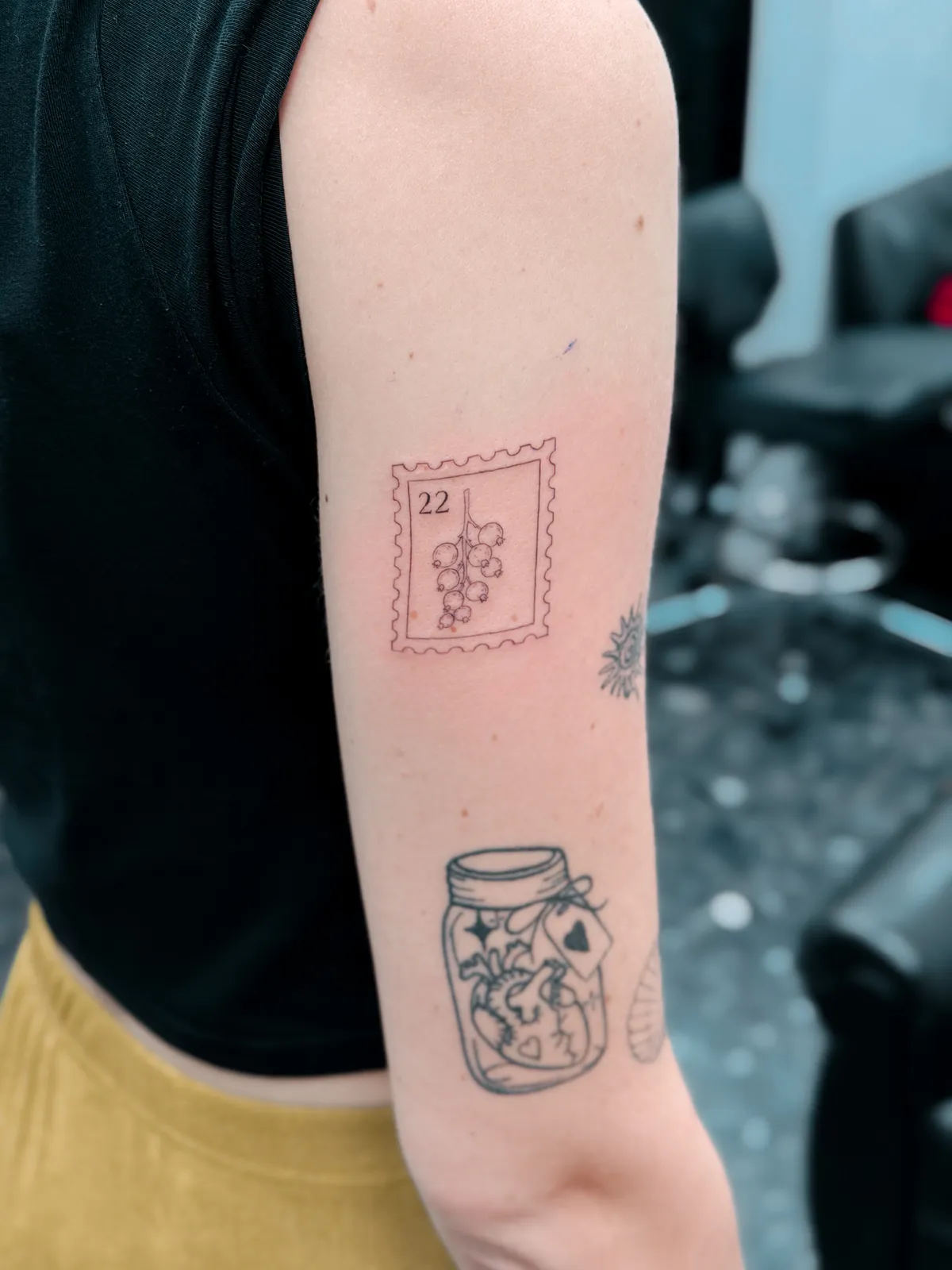 Fine line postage stamp and jar of flowers on the arm by Hugo Gonzalez