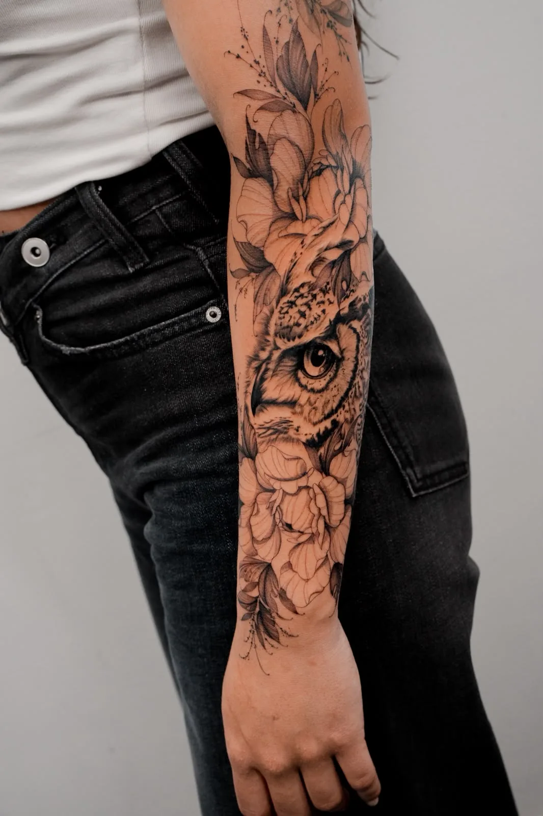 Owl among flowers on the forearm — tattoo by Hugo Gonzalez, Funchal, Madeira