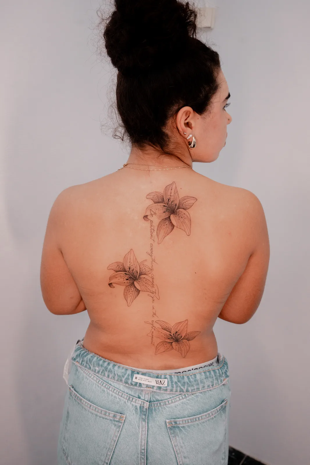 Three lilies traced down the spine by Hugo Gonzalez