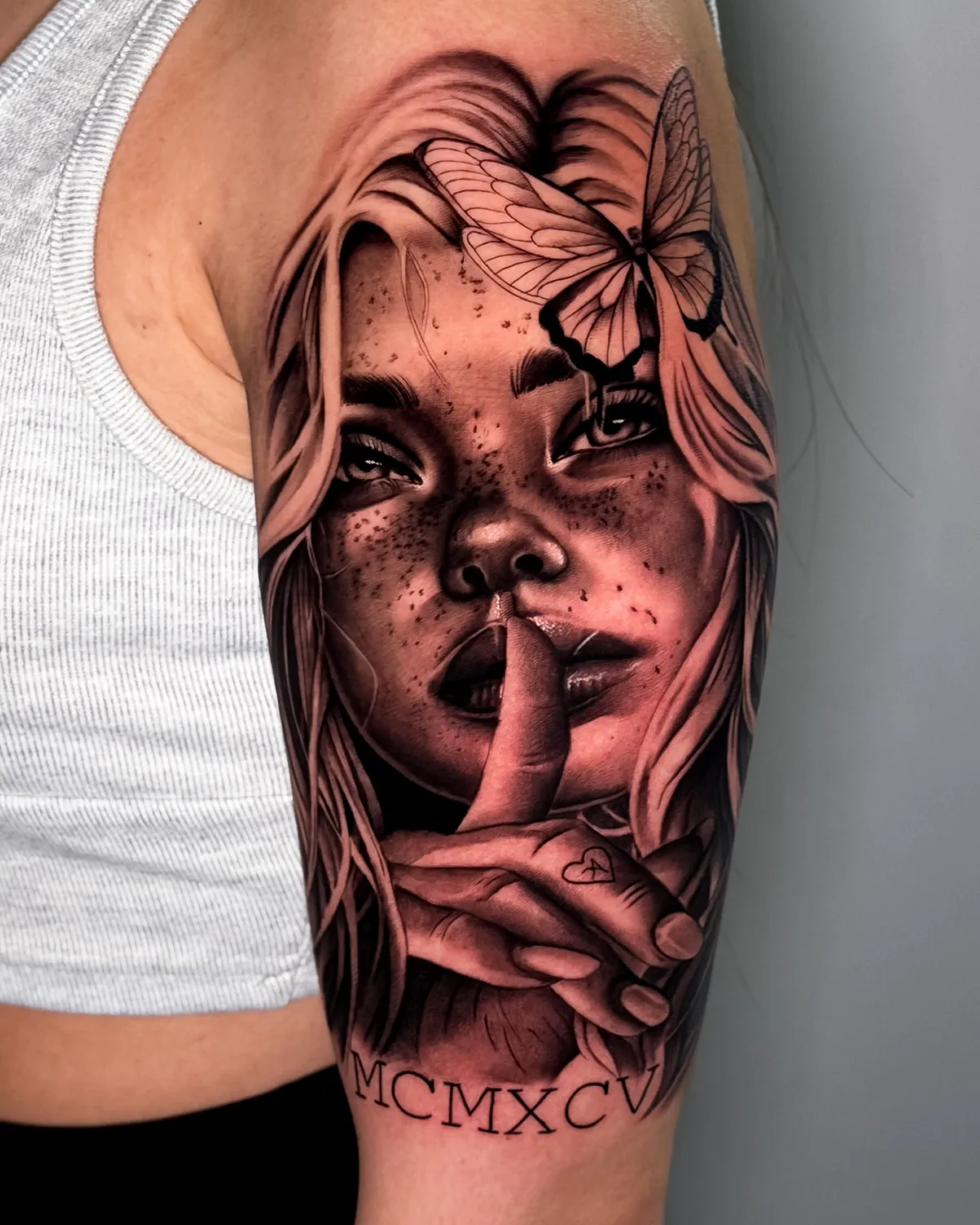 Black and grey portrait of a woman with a butterfly by Hugo Gonzalez