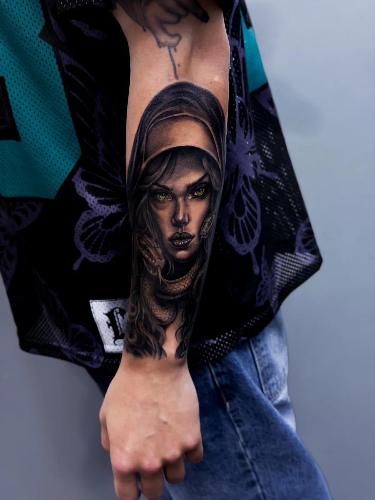 Black and grey veiled portrait on the forearm by Hugo Gonzalez